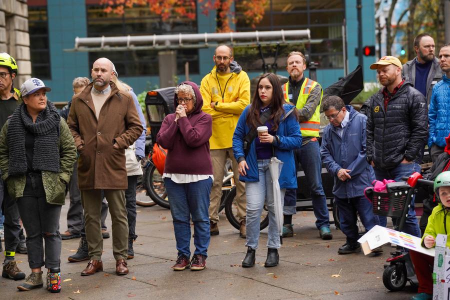 group of politicians standing around with somber looks on their faces